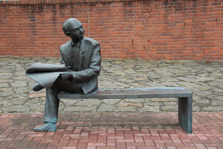 Man, newspaper, read — Luxury Living vs Affordable Housing in Singapore: Which Investment Strategy Works Best?