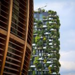 Two residential buildings with green terraces showcasing sustainable architecture