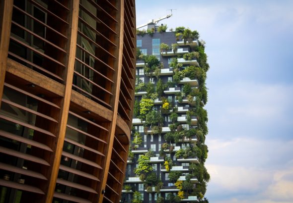 Two residential buildings with green terraces showcasing sustainable architecture