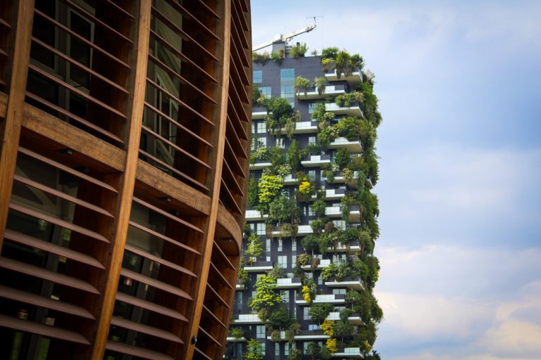 Two residential buildings with green terraces showcasing sustainable architecture