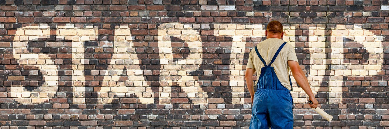 Startup, wall, painter — What to Expect from Volunteer Programs Abroad: Everything You Need to Know